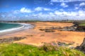 Harlyn Bay beach North Cornwall England UK near Padstow and Newquay in colourful HDR with cloudscape Royalty Free Stock Photo