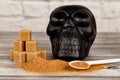 Harm of sugar concept. Cubes of sugar and black skull figure