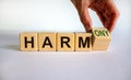 From harm to harmony. Male hand turns the cube and changes word `harm` to `harmony`. Beautiful white background. Business and