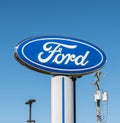 Harmar Township, Pennsylvania, USA May 8, 2022 Isolated oval shaped Ford logo, the automobile, with a blue sky background