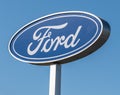 Harmar Township, Pennsylvania, USA May 8, 2022 Isolated oval shaped Ford logo, the automobile, with a blue sky background