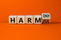 From harmful to harmony symbol. Turned a wooden cube and changed word harmful to harmony. Beautiful orange table, orange