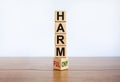 From harmful to harmony. Turned the wooden cube and changed the word `harmful` to `harmony`. Beautiful wooden table, white