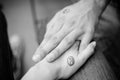 Black and white pictures. Two hands holding each other with yin and yang symbols. Royalty Free Stock Photo