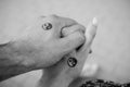 Black and white pictures. Two hands holding each other with yin and yang symbols. Royalty Free Stock Photo