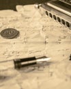 Harmonica copper coin and fountain pen on an old paper vintage music sheet