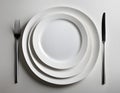 A harmonious composition of stacked white plates, arranged in a clean and elegant manner against a Royalty Free Stock Photo