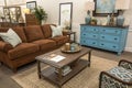 Harmonized living room with brown sofa and blue commode Royalty Free Stock Photo
