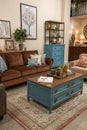 Harmonized living room with brown sofa and blue commode Royalty Free Stock Photo
