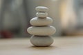 Harmony and balance, cairns, simple poise pebbles on wooden light white gray background, simplicity rock zen sculpture