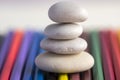 Harmony and balance, cairns, simple poise stones on colorful background, rock zen sculpture, white pebbles, single tower Royalty Free Stock Photo