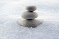 Harmony and balance, cairns, simple poise stones on white background, rock zen sculpture, white pebbles, single tower, simplicity Royalty Free Stock Photo