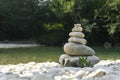 Harmony, balance and simplicity concept. A stone pyramid on the background of river water. Simple poise pebbles, rock zen Royalty Free Stock Photo