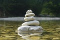 Harmony, balance and simplicity concept. A stone pyramid on the background of river water. Simple poise pebbles, rock zen Royalty Free Stock Photo