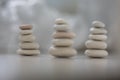 Harmony and balance, three cairns, simple poise pebbles on wooden light white gray background, simplicity rock zen sculpture Royalty Free Stock Photo