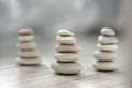 Harmony and balance, three cairns, simple poise pebbles on wooden light white gray background, simplicity rock zen sculpture Royalty Free Stock Photo