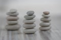 Harmony and balance, three cairns, simple poise pebbles on wooden light white gray background, simplicity rock zen sculpture Royalty Free Stock Photo