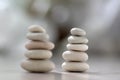 Harmony and balance, two cairns, simple poise pebbles on wooden light white gray background, simplicity rock zen sculpture Royalty Free Stock Photo