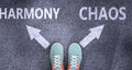 Harmony and chaos as different choices in life - pictured as words Harmony, chaos on a road to symbolize making decision and