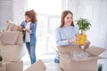 Upbeat female students unpacking belongings together Royalty Free Stock Photo