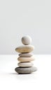 Harmony in Zen stone. Balanced stack of rocks symbolizes serenity and mental clarity. Neutral color, gray and white background, Royalty Free Stock Photo