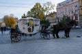 Harnessed horses in a carriage jump through the city of Lviv