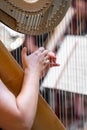 harp on symphony orchestra stage, detail of hands with strings Royalty Free Stock Photo