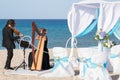 Harp and violin concert at the seaside for the wedding day