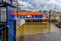 The Harpy houseboat illuminated by morning sunlight on the south bank of the River Thames, Bermondsey, London, England Royalty Free Stock Photo