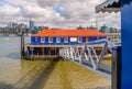 The Harpy houseboat illuminated by morning sunlight on the south bank of the River Thames, Bermondsey, London, England Royalty Free Stock Photo