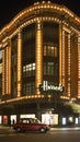 Harrods department store. Taxi passes in front of it