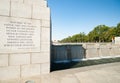 Harry S truman quote remembering the nations debt to the herois engraved in stone on wall by National Mall water feature