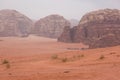 Harsh desert landscape with bizarre cliffs and red sand. Shot in Jordan Royalty Free Stock Photo