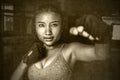 Harsh grunge beautiful sweaty Asian woman in fighting gloves fitness combat concept