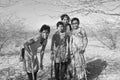 Young indian girls chopping down wood at the national park Little Rann of Kutch in the Gujarat salt-desert Royalty Free Stock Photo