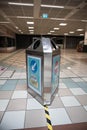 Direction signs for social distancing on a waste bin in a shopping centre mall