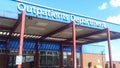 Entrance to Outpatients Department at healthcare hospital building showing sign