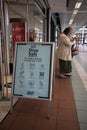 Social Distance information reminder sign at entrance to Boots pharmacy chemist in shopping centre mall