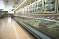 Supermarket display of frozen food for purchase in freezers