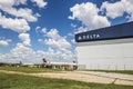 Hartsfield ackson Atlanta International Airport landscape view of a Delta building and planes with blue sky and clouds