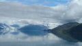 Harvard Glacier at the end of College Fjord Alaska. Wide glacier carving its path to the sea. Mountains peaks water and clouds Royalty Free Stock Photo