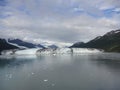 Harvard Glacier at the end of College Fjord Alaska. Wide glacier carving its path to the sea. Mountains peaks water and clouds Royalty Free Stock Photo