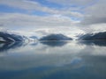 Harvard Glacier at the end of College Fjord Alaska. Wide glacier carving its path to the sea. Mountains peaks water and clouds Royalty Free Stock Photo