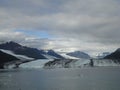 Harvard Glacier at the end of College Fjord Alaska. Wide glacier carving its path to the sea. Mountains peaks water and clouds Royalty Free Stock Photo