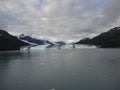 Harvard Glacier at the end of College Fjord Alaska. Wide glacier carving its path to the sea. Mountains peaks water and clouds Royalty Free Stock Photo