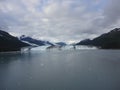 Harvard Glacier at the end of College Fjord Alaska. Wide glacier carving its path to the sea. Mountains peaks water and clouds Royalty Free Stock Photo