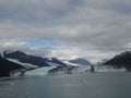 Harvard Glacier at the end of College Fjord Alaska. Wide glacier carving its path to the sea. Mountains peaks water and clouds Royalty Free Stock Photo