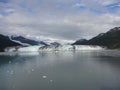 Harvard Glacier at the end of College Fjord Alaska. Wide glacier carving its path to the sea. Mountains peaks water and clouds Royalty Free Stock Photo