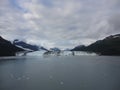 Harvard Glacier at the end of College Fjord Alaska. Wide glacier carving its path to the sea. Mountains peaks water and clouds Royalty Free Stock Photo