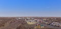 Harve, Montanna, USA - March 2017. The town of Harve's main hub, highway, railway tracks and train with clear blue sky.